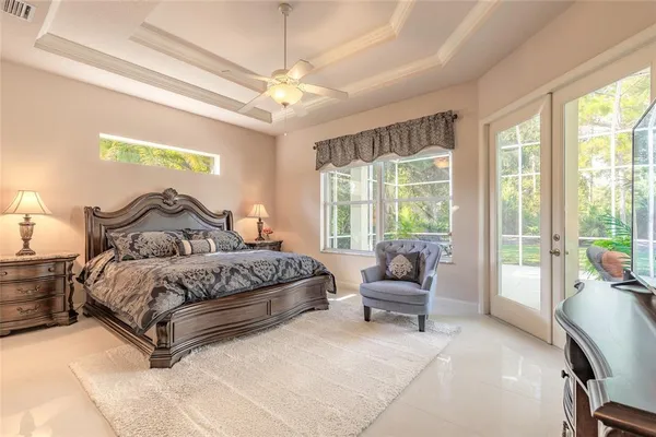 a spacious bedroom with a bed and large window