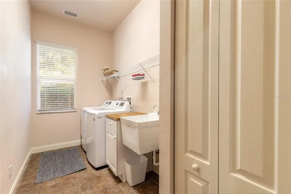 a view of a chair and tables in the patio in front of a house