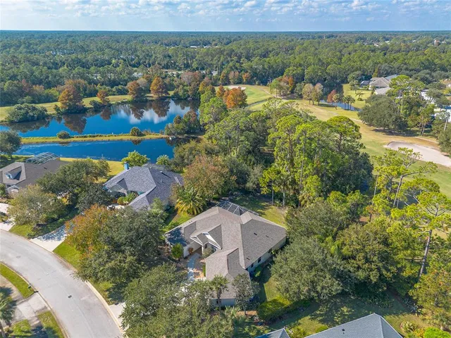 an aerial view of a houses with a yard