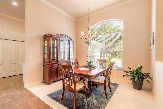 a view of a dining room with furniture and a chandelier