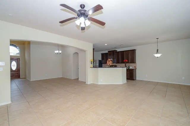 a kitchen with granite countertop a sink flowers and cabinets