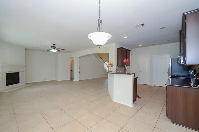 a kitchen with granite countertop a sink and cabinets