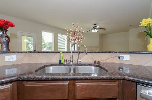 a kitchen with stainless steel appliances granite countertop a sink stove and microwave