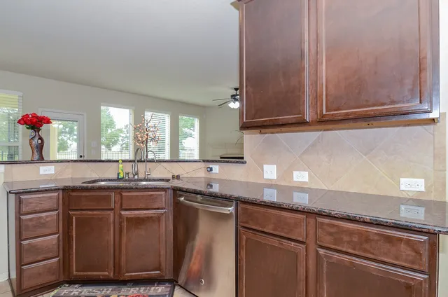 a kitchen with stainless steel appliances granite countertop a refrigerator stove and microwave