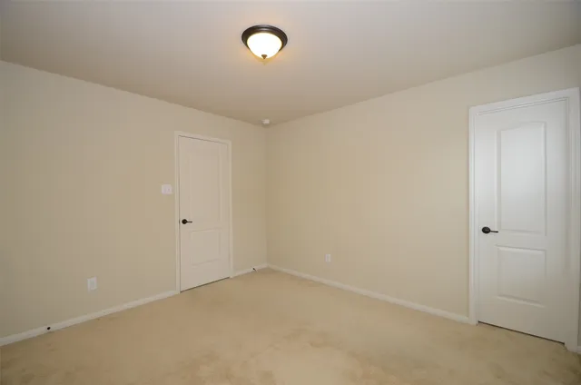 a view of a house with a wooden fence