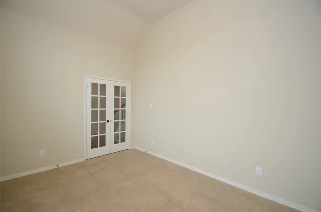 a view of a hallway with windows and chandelier
