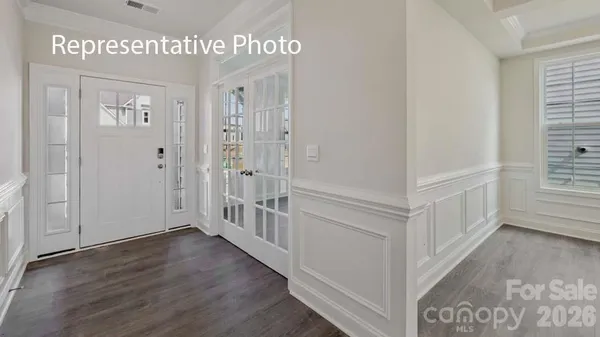 a view of an entryway with wooden floor