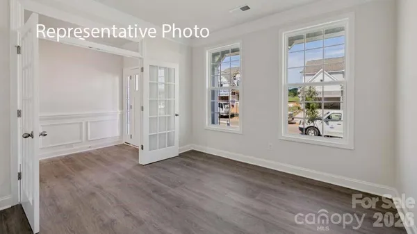 a view of an empty room with window and cabinet