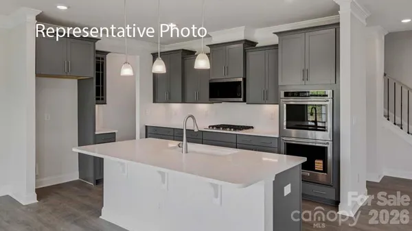 a kitchen with stainless steel appliances a refrigerator and a stove top oven