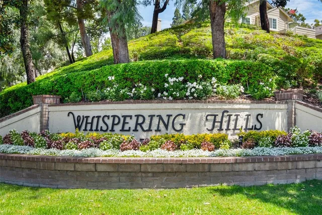 a street sign that is sitting in front of flowers