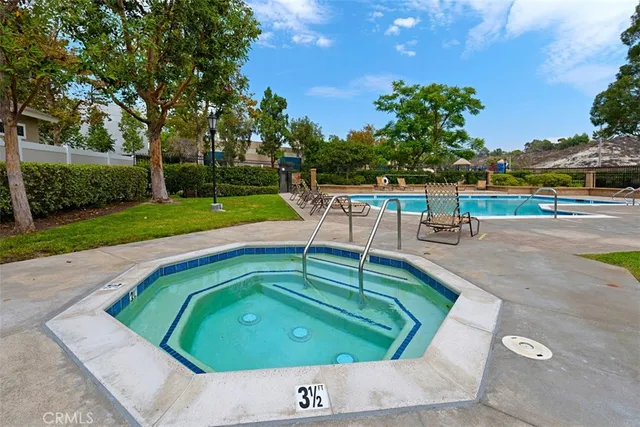 a view of a swimming pool with a yard and trees