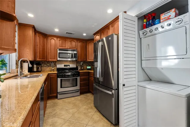 a kitchen with a refrigerator sink and microwave