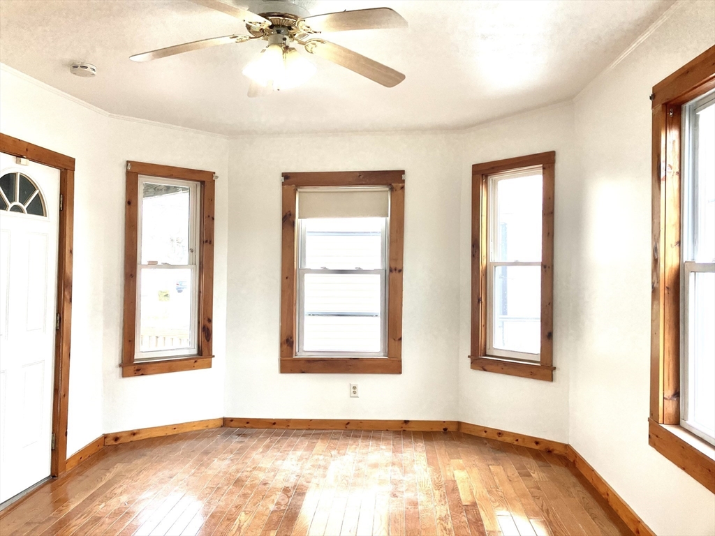4 Sisson Terrace, Unit 1 Lynn, MA 01902 - Photo 11 of 16 a view of an empty room with a window and wooden floor