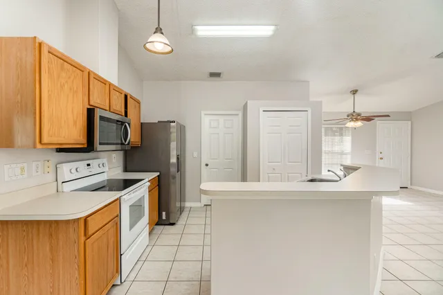 a bathroom with a sink a mirror a toilet and shower
