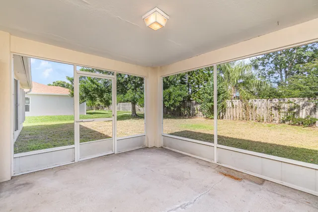 a view of backyard of house with green space