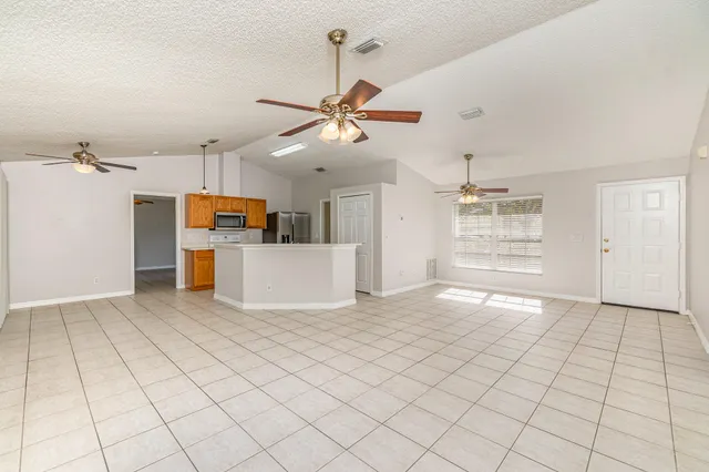 a view of a kitchen with furniture and a ceiling fan