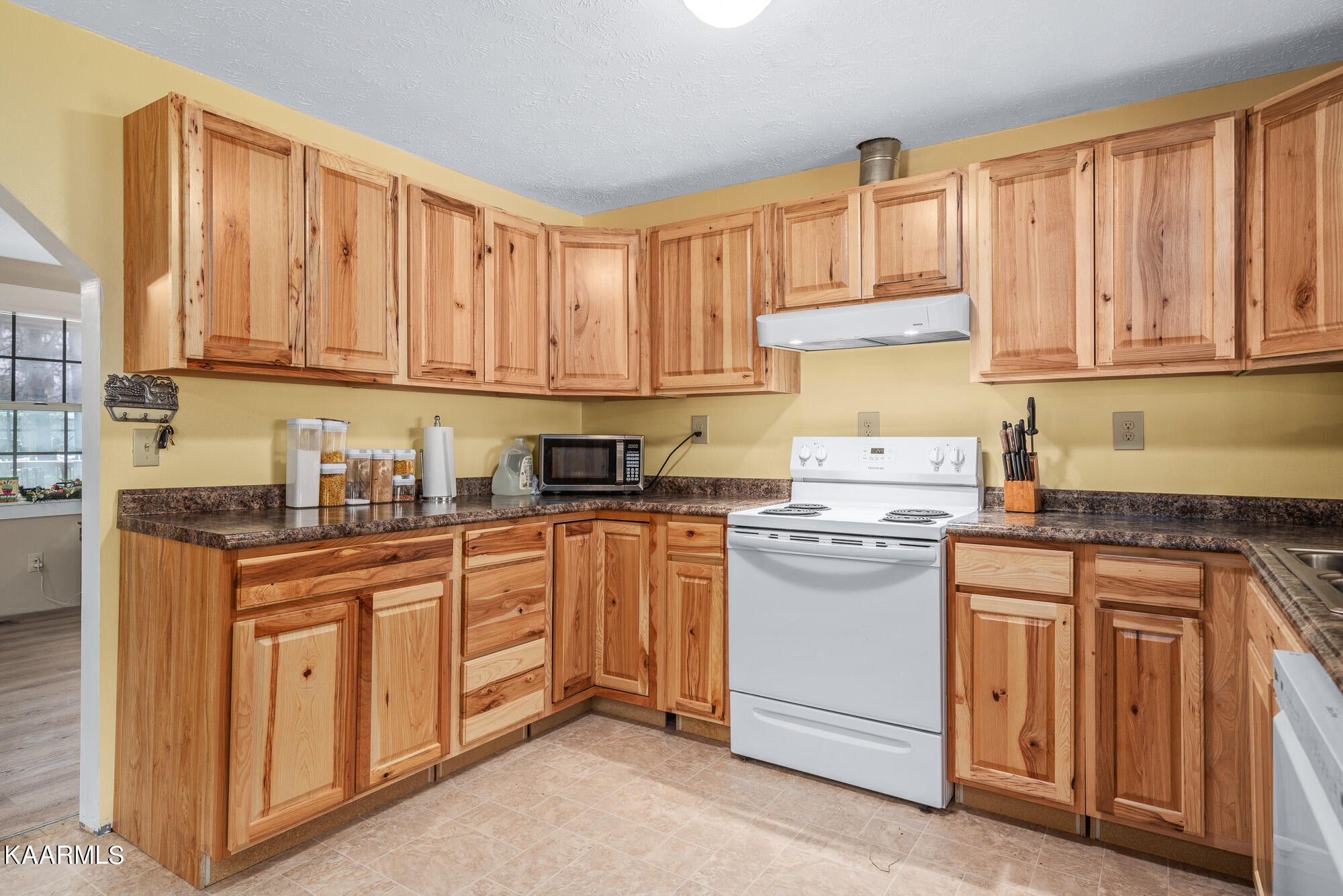 2371 Roslin Road Jamestown, TN 38556 - Photo 19 of 38 a kitchen with stainless steel appliances granite countertop a stove sink and cabinets