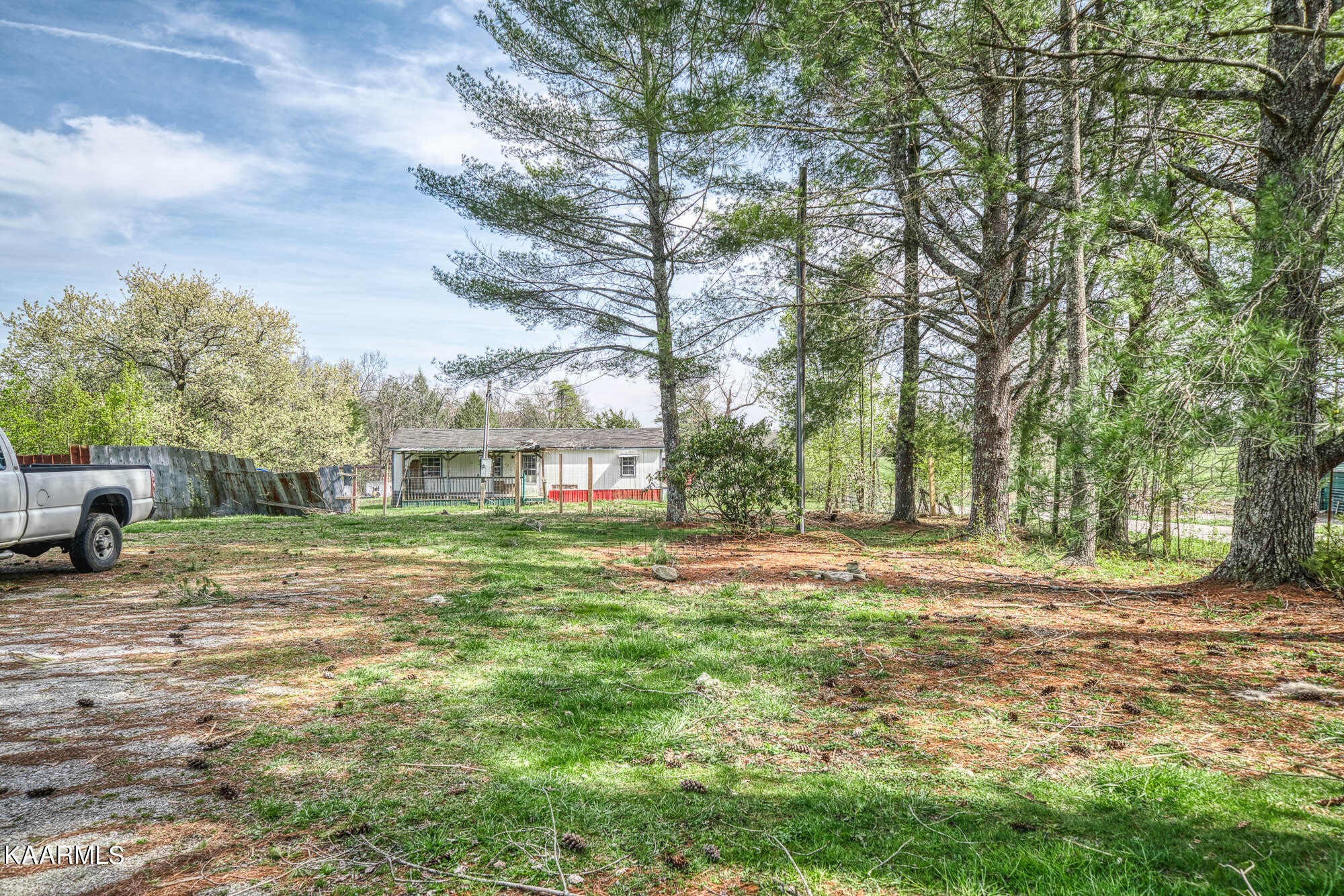 2371 Roslin Road Jamestown, TN 38556 - Photo 6 of 38 a view of a house with a yard covered in the forest