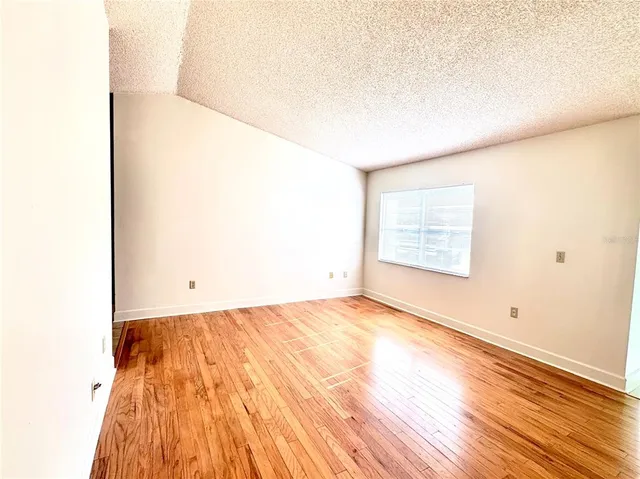 a view of a room with wooden floor