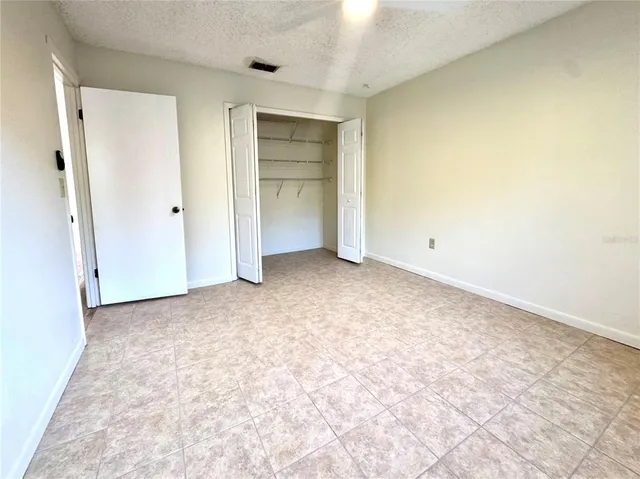 an empty room with closet and bathroom