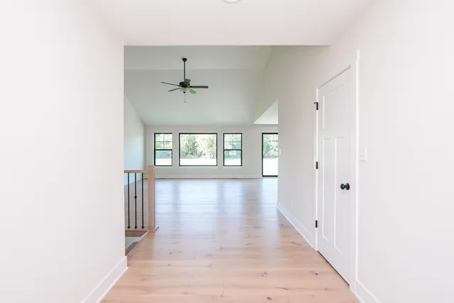 a view of a hallway with a window and a chandelier