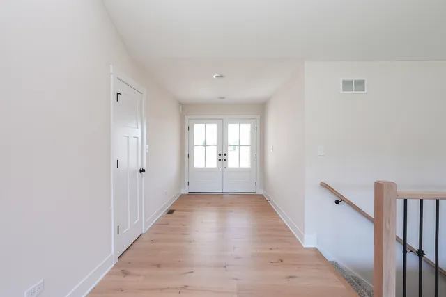 a big room with wooden floor and windows