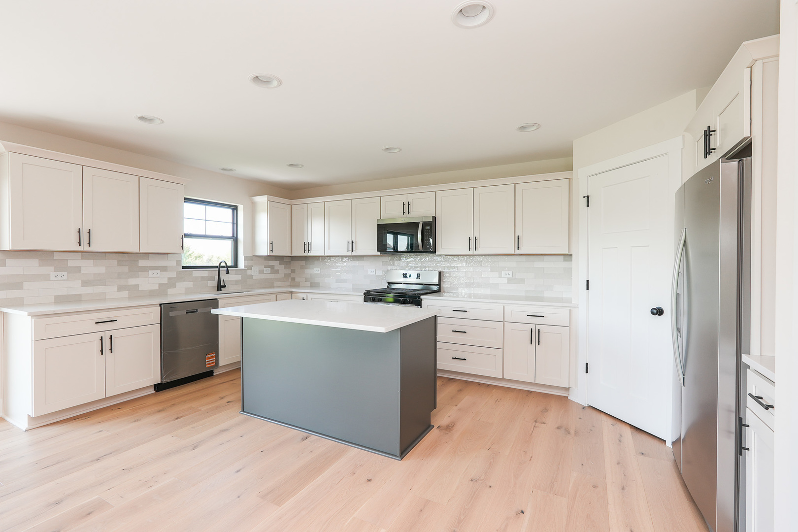 985 Spring Street Manteno, IL 60950 - Photo 18 of 46 a kitchen with cabinets appliances a sink and a window