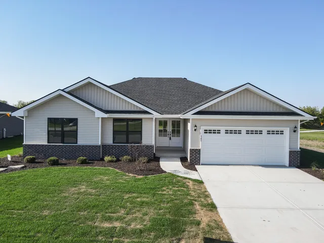 a front view of house with yard and green space