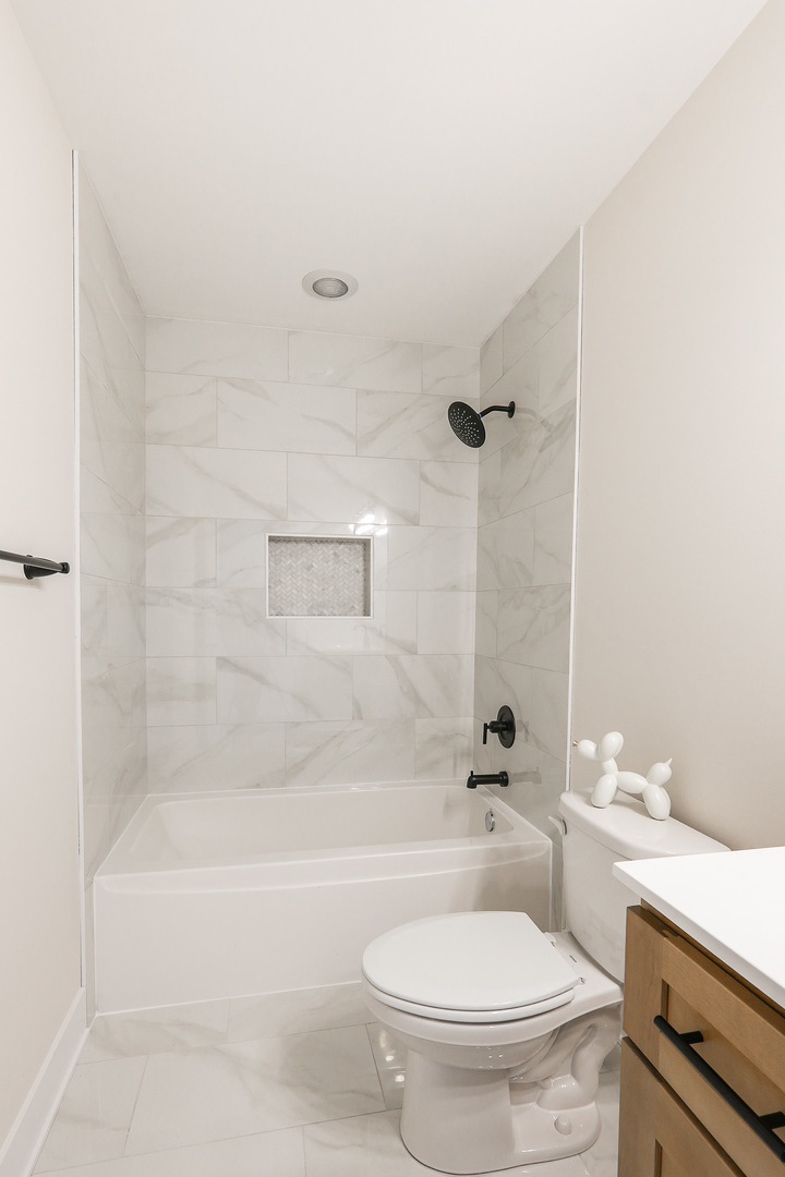 985 Spring Street Manteno, IL 60950 - Photo 32 of 46 a white toilet sitting next to a bath tub