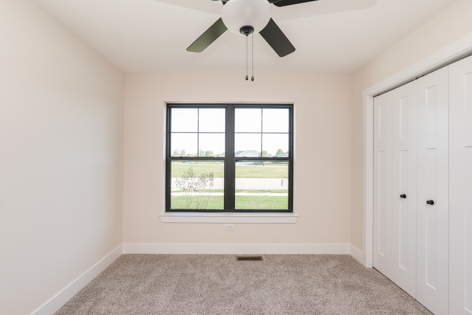 985 Spring Street Manteno, IL 60950 - Photo 37 of 46 an empty room with a window and a ceiling fan