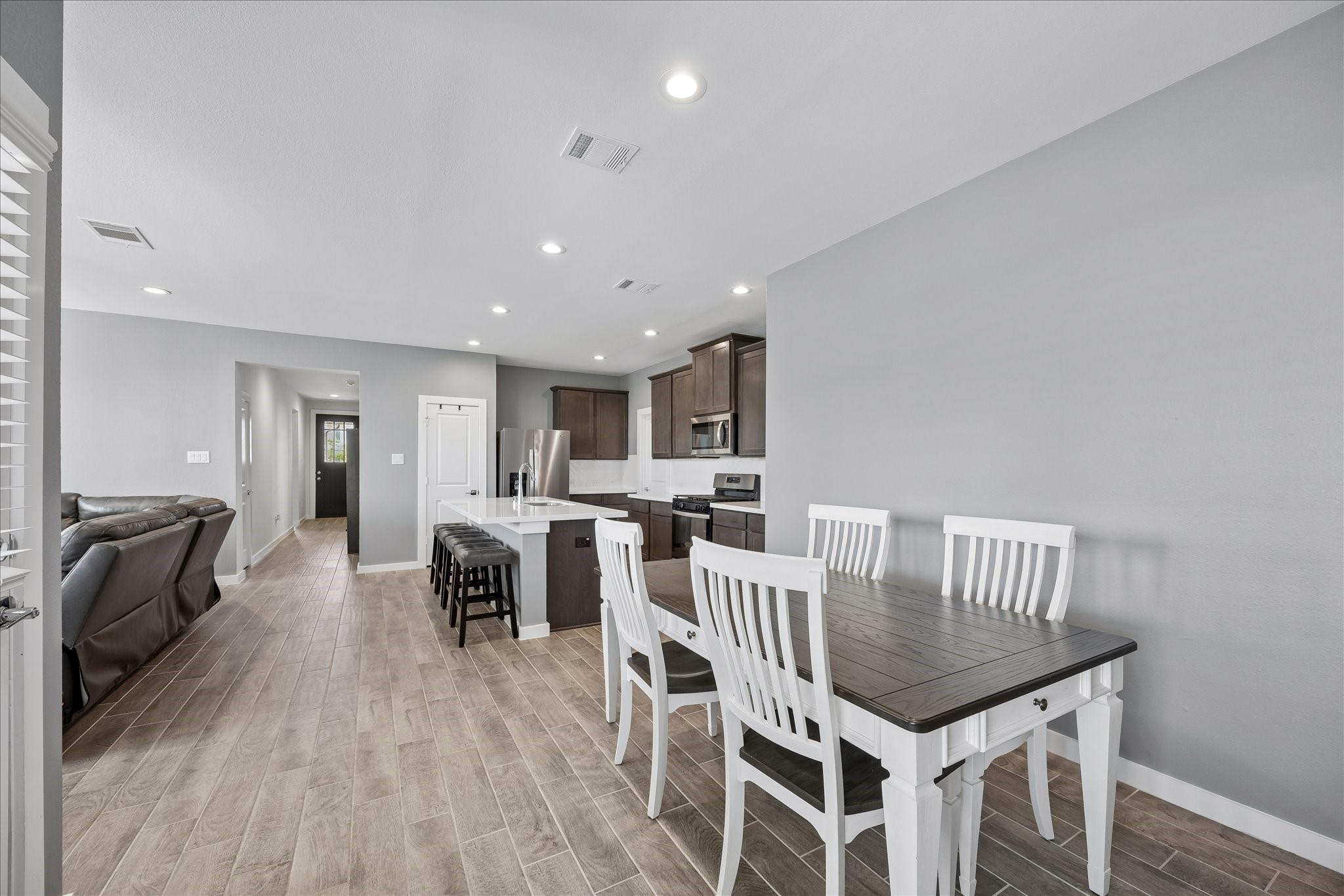 33002 Carolyns Perfection Loop Fulshear, TX 77441 - Photo 13 of 29 a view of a dining room with furniture and wooden floor