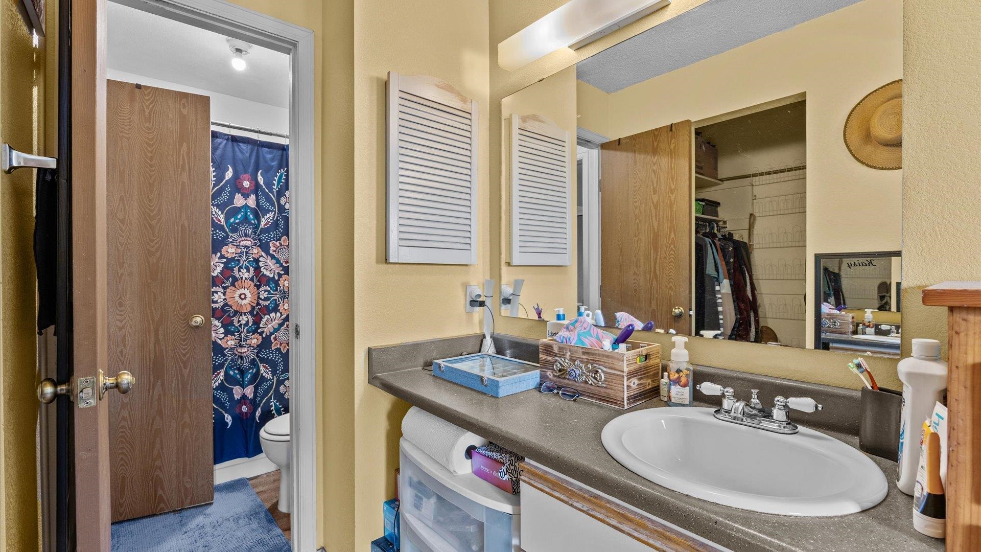 264 Coventry Court, Unit 32 Grand Junction, CO 81503 - Photo 14 of 17 a en suite bathroom with a granite countertop sink and a mirror