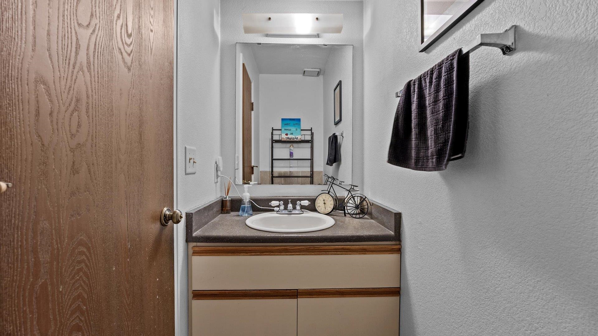 264 Coventry Court, Unit 32 Grand Junction, CO 81503 - Photo 15 of 17 a bathroom with a sink a mirror and a shower