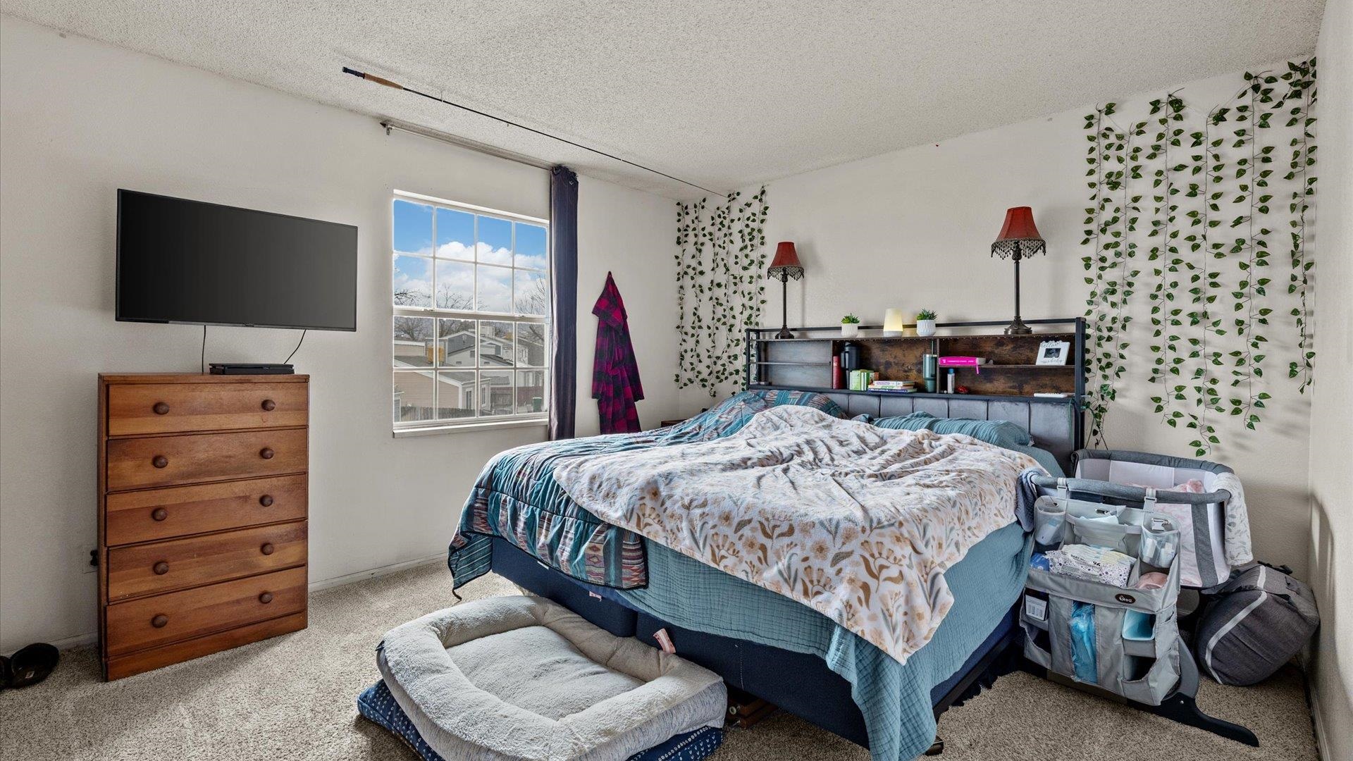 264 Coventry Court, Unit 32 Grand Junction, CO 81503 - Photo 9 of 17 a bedroom with a bed and a flat screen tv