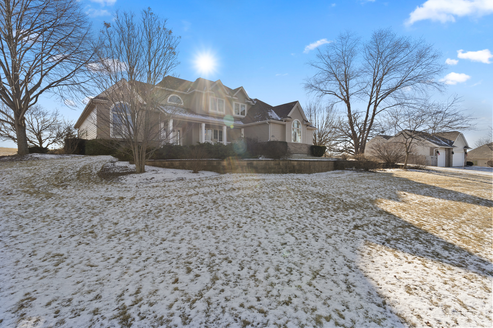 a view of a white house with a yard covered in snow