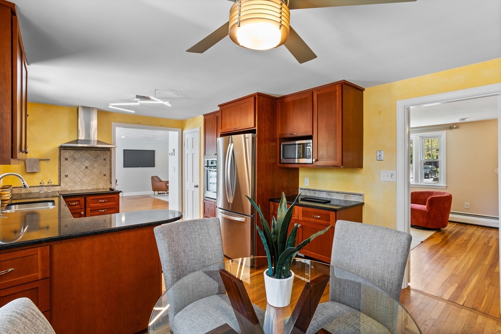 17 Hamblen Street Lexington, MA 02421 - Photo 11 of 42 a living room with furniture a flat screen tv and kitchen view