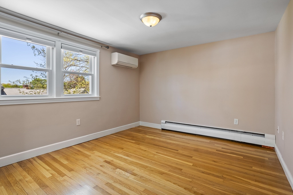 17 Hamblen Street Lexington, MA 02421 - Photo 27 of 42 a view of an empty room with wooden floor and a window