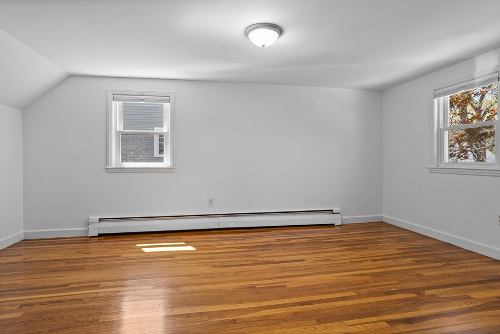 17 Hamblen Street Lexington, MA 02421 - Photo 30 of 42 a view of an empty room with wooden floor and a window