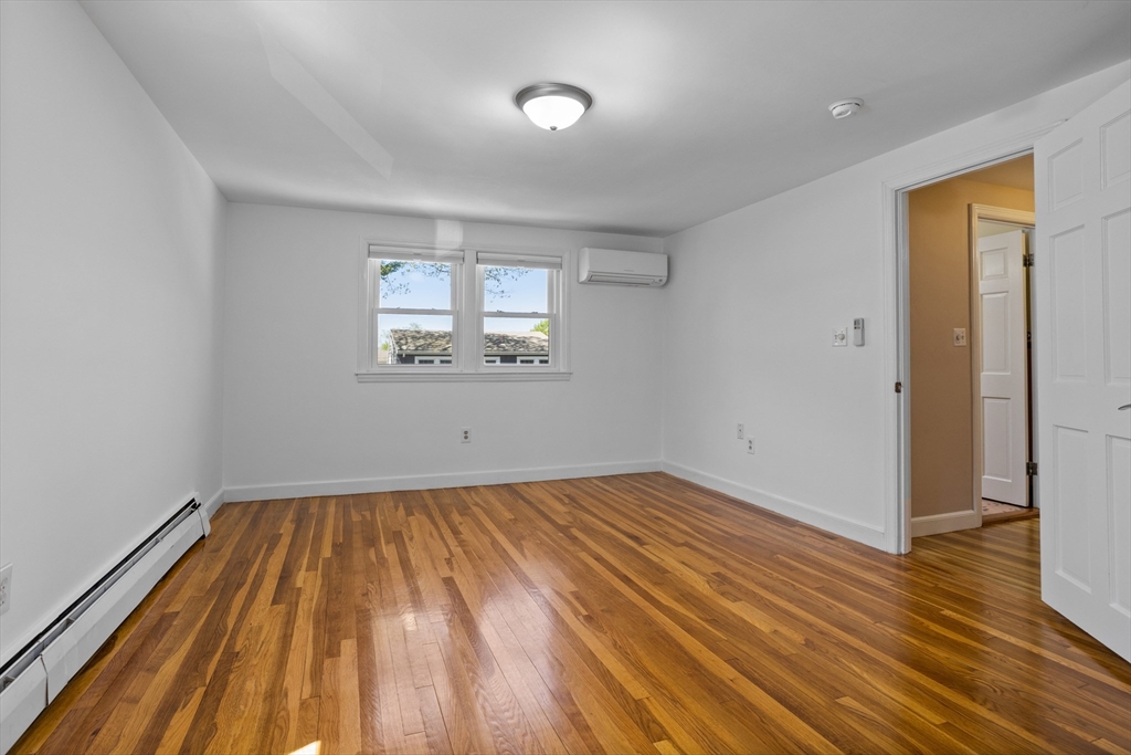 17 Hamblen Street Lexington, MA 02421 - Photo 31 of 42 wooden floor in an empty room with a window