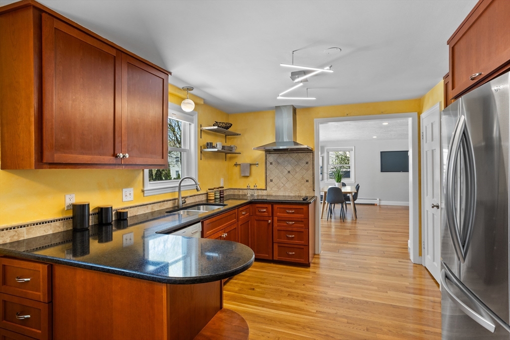 17 Hamblen Street Lexington, MA 02421 - Photo 6 of 42 a kitchen with stainless steel appliances granite countertop a sink a stove and a refrigerator