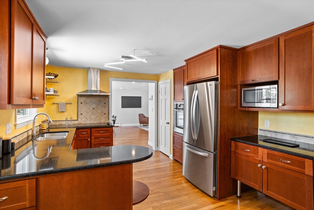 17 Hamblen Street Lexington, MA 02421 - Photo 7 of 42 a kitchen with stainless steel appliances granite countertop a refrigerator and a sink