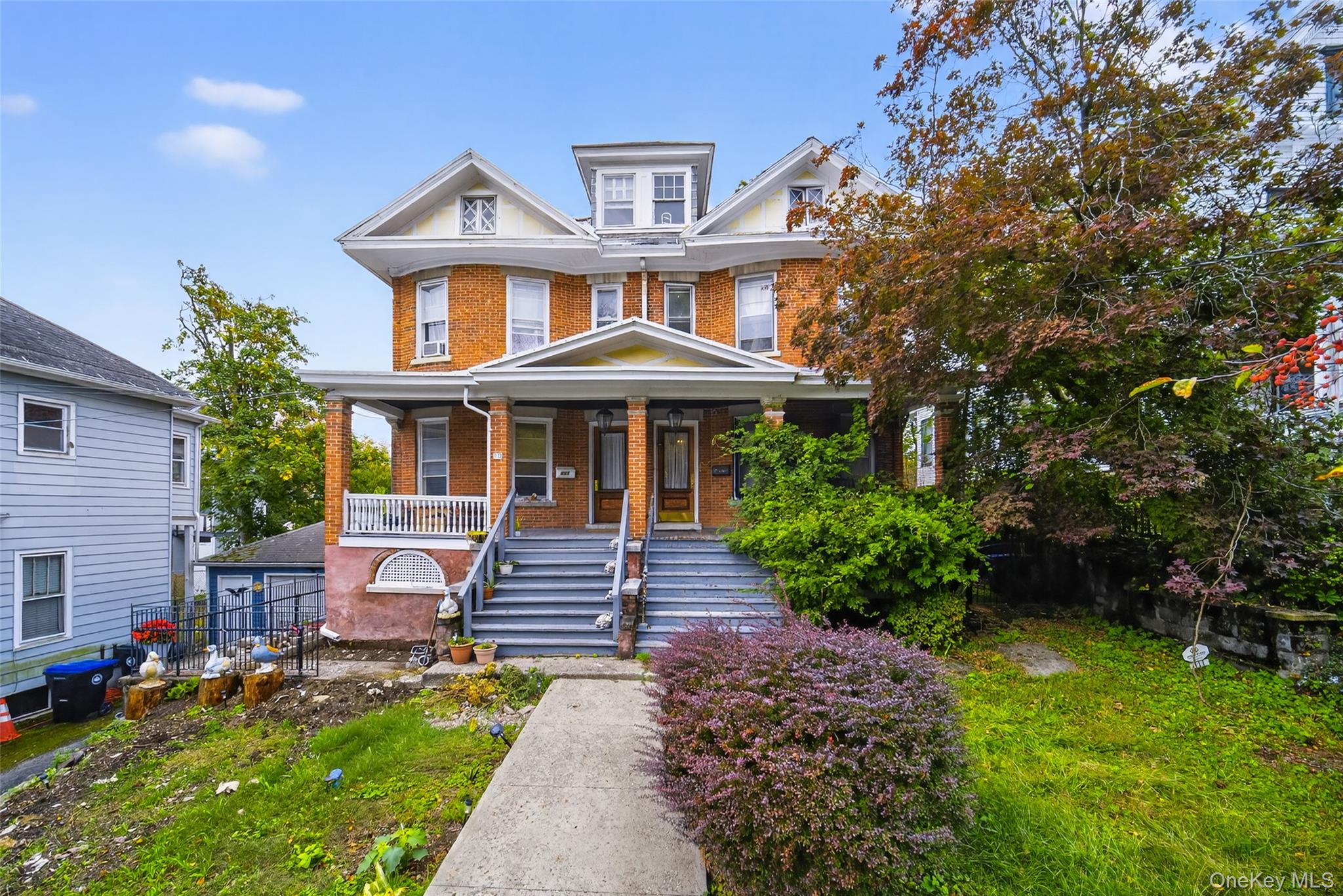a front view of a house with a yard table and chairs