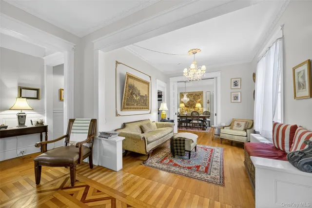 a living room with fireplace furniture and a chandelier
