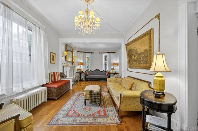 a living room with furniture and a chandelier