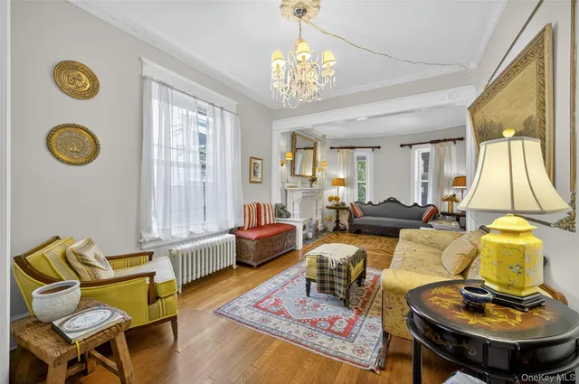 a living room with furniture and a chandelier