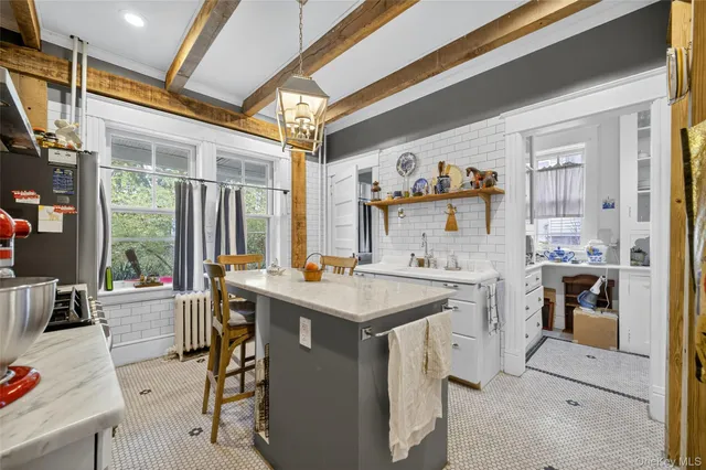 a kitchen with stainless steel appliances kitchen island granite countertop a refrigerator and a stove