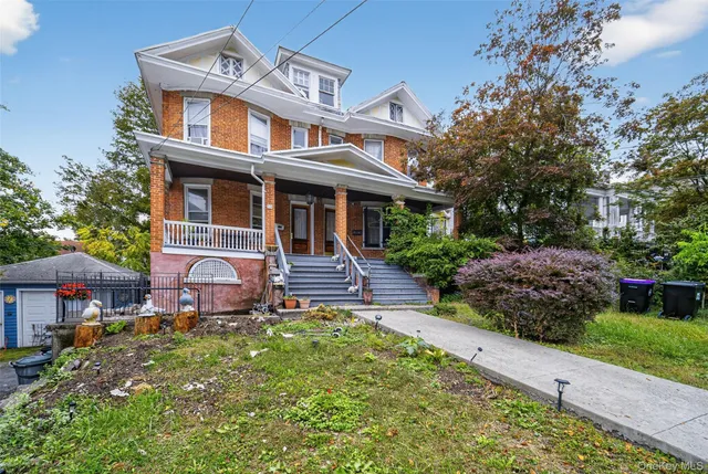 a front view of a house with a garden