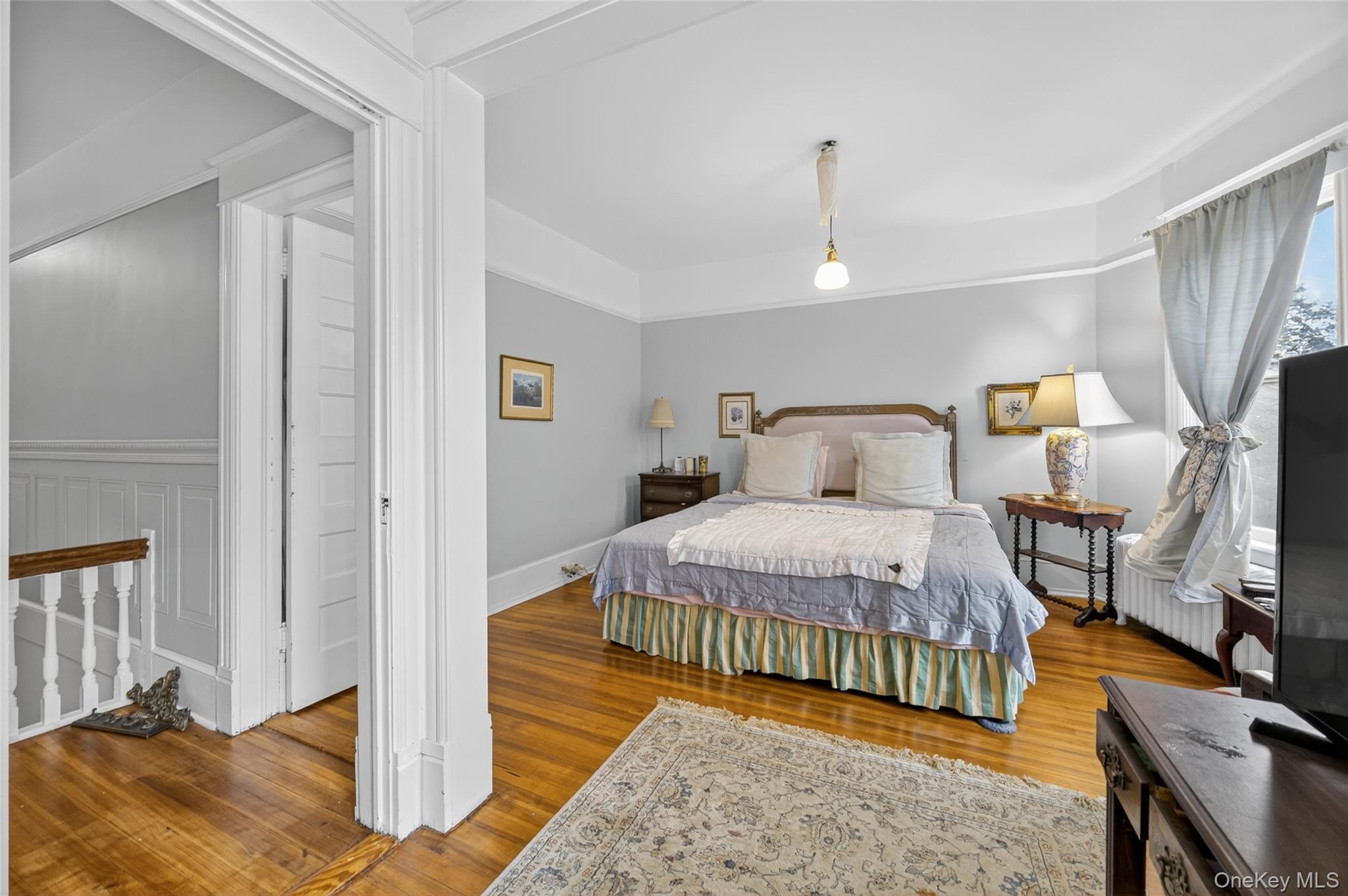 111 South Hamilton Street Poughkeepsie, NY 12601 - Photo 27 of 46 a bedroom with a bed and wooden floor