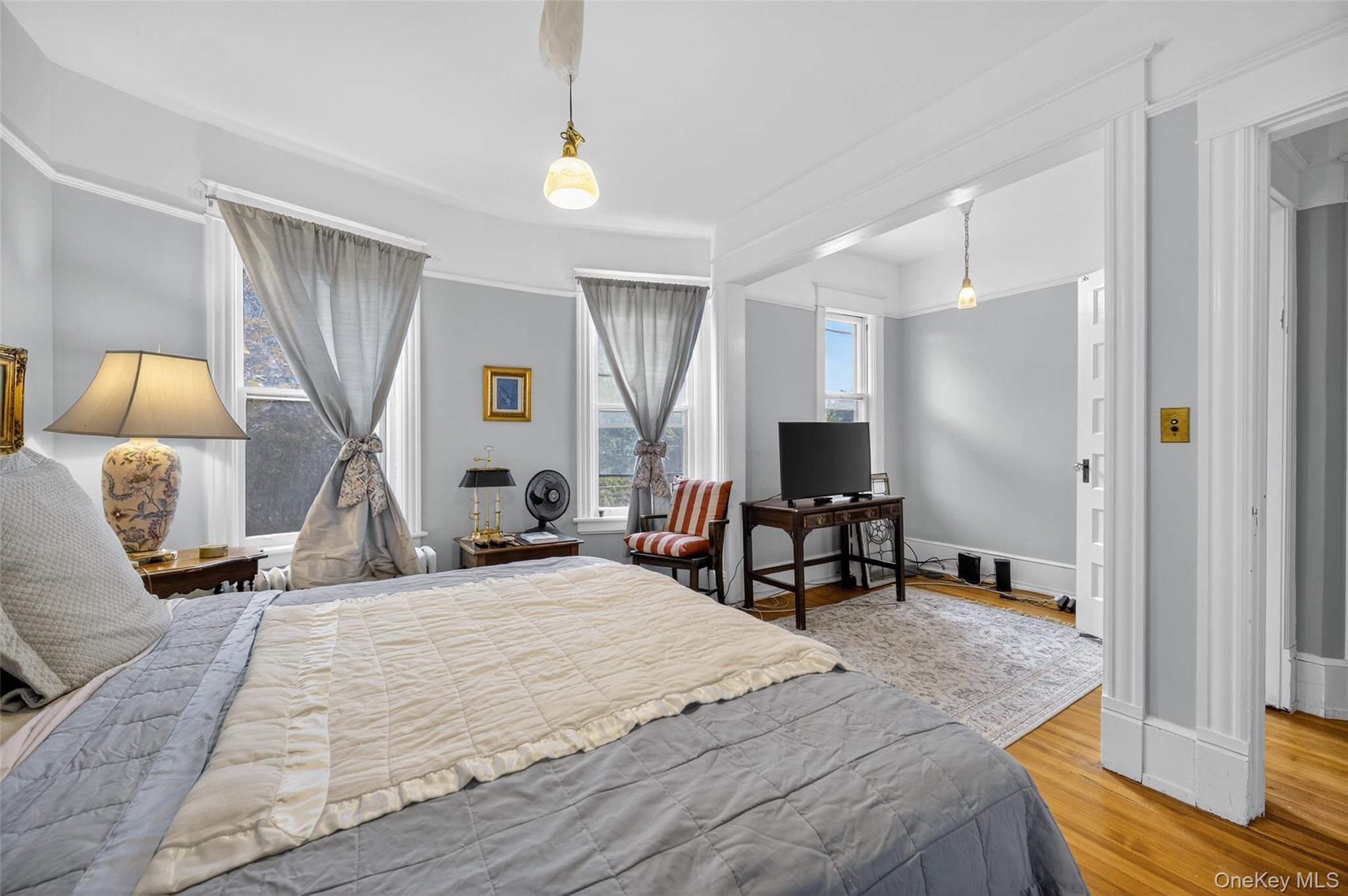 111 South Hamilton Street Poughkeepsie, NY 12601 - Photo 28 of 46 a bedroom with a bed a table and a flat screen tv