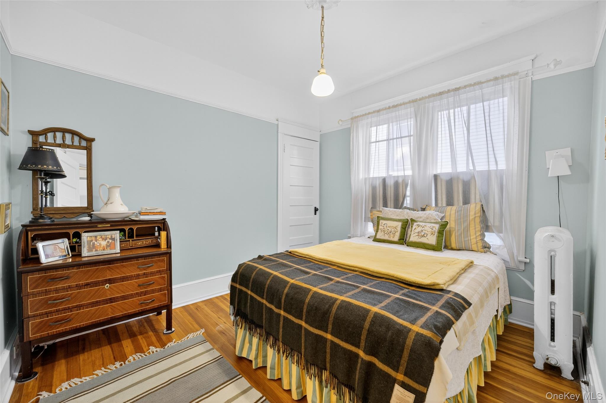 111 South Hamilton Street Poughkeepsie, NY 12601 - Photo 35 of 46 a bedroom with a bed and wooden floor